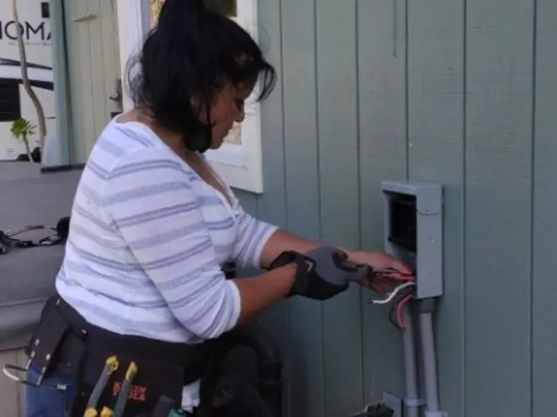 Licensed electrician wiring an exterior subpanel in Island Park