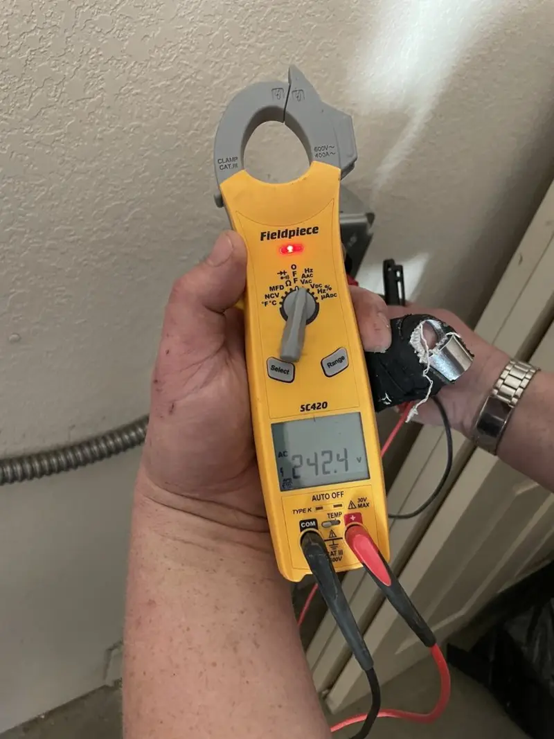 Voltage testing with clamp meter during Electrical Installation Services in Island Park